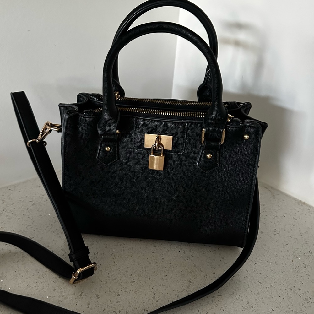 Black leather purse with gold detailing perfect condition striped interior